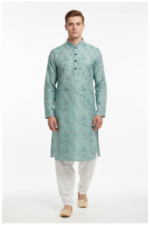Teal blue Arvind jacquard cotton unstitched shirting fabric showing intricate woven pattern and fabric texture.