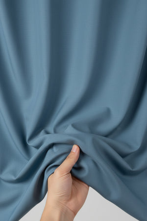 Denim blue Tessuti satin unstitched shirting fabric from Mensfabric, smooth and plain fabric suitable for shirts and apparel.