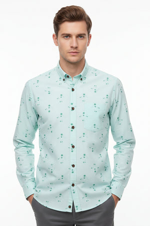 Light blue readymade shirt fabric with green floral patterns and '100% Cotton' label.
