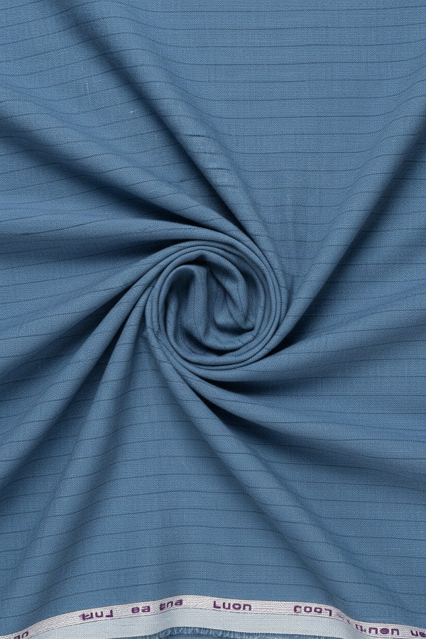 Blue striped linen shirting fabric by Arvind, showing a close-up of the textured linen material with vertical stripe pattern.