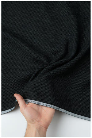 Dark green unstitched Primante cotton shirting fabric by Arvind, showing a close-up of the textured woven material.