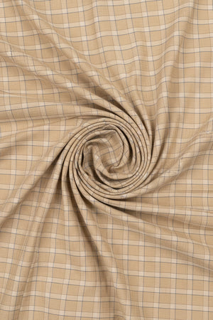 Unstitched Tresca cotton checks shirting fabric in tan by Arvind, showing the textured fabric pattern and lightweight material
