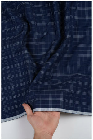 Navy blue Tresca cotton checks shirting fabric by Arvind, showcasing a close-up of the textured checked pattern.