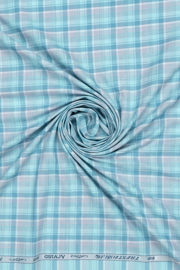 Close-up of Arvind Tresca cotton shirting fabric with blue check pattern and clear blue background.