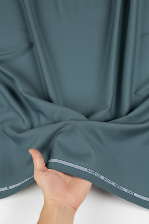 Arvind Tresca cotton plain shirting fabric in seagreen color with smooth texture and lightweight feel.