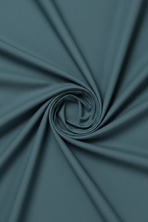 Light seagreen Arvind Tresca cotton plain shirting fabric with a smooth texture and subtle weave pattern.