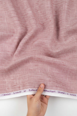 Light coral Arvind Tresca Linen plain shirting fabric roll with visible texture and soft drape, ideal for stylish clothing projects.