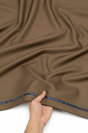 Brown Arvind Cotton Lycra stretchable trouser and suiting fabric, showing the textured woven material and fabric detail.