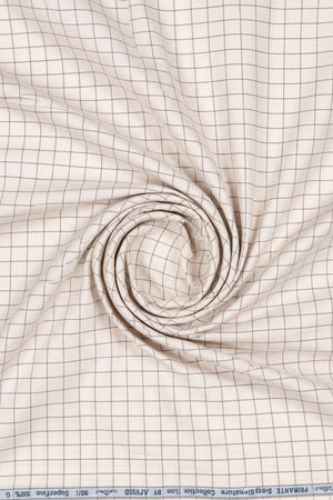 Beige Arvind cotton shirting fabric with a smooth texture, suitable for shirts and tailored clothing designs.