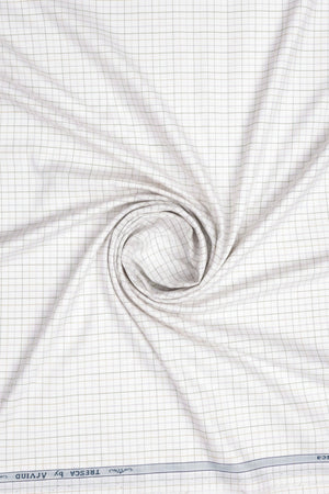 Yellow checkered cotton shirt fabric from Arvind Tresca collection, featuring white background and premium quality design.