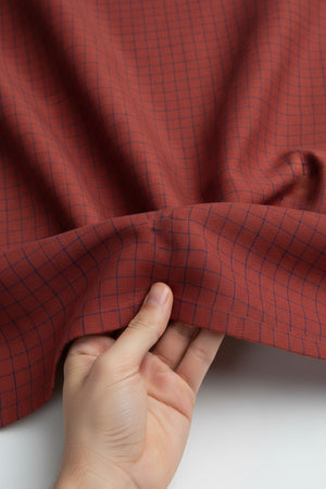 Red and blue checked Arvind linen shirt fabric, showcasing a soft, breathable material perfect for stylish casual wear.