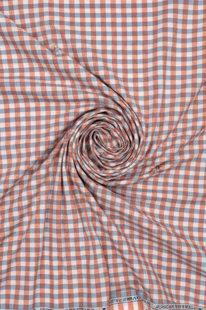 Checkered fabric with red and blue pattern, branded 'Tresca by Arvind Urban Solace Collection'.