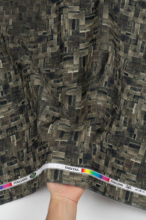 Printed fabric pattern with green and black digital geometric print