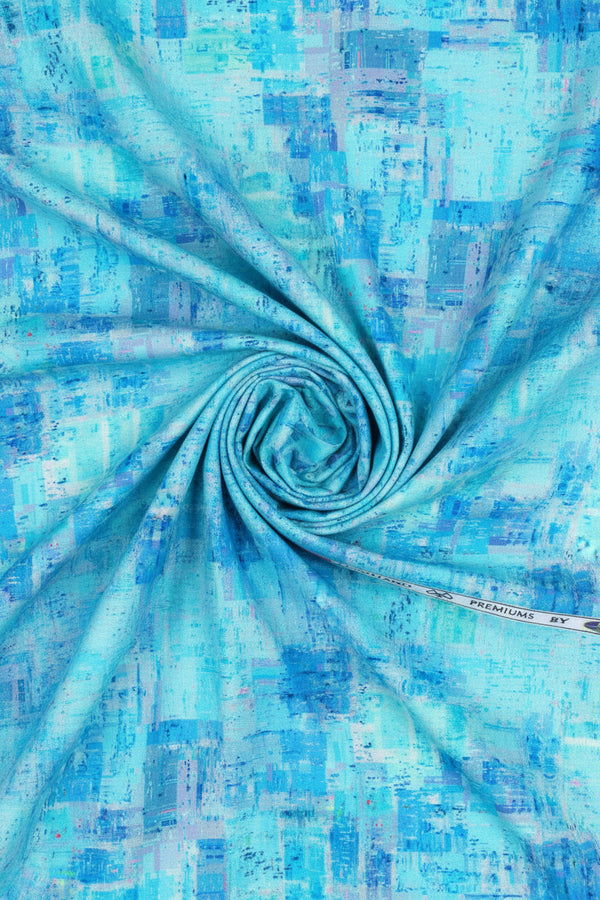 Blue Pee Gee cotton shirt fabric with digital print, showing a close-up of the vibrant patterned textile design.