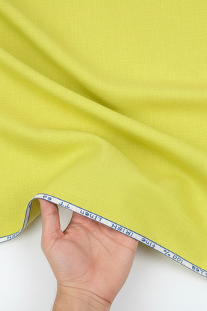 A close-up of a bright yellow-green linen fabric texture with a white header strip at the top containing blue printed text.