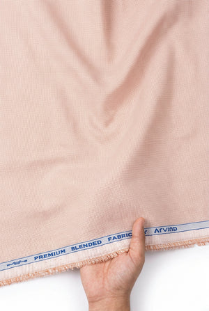 Peach Arvind Signature cotton polycot shirt fabric roll with textured weave, ideal for making stylish shirts and garments.