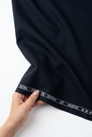 Navy blue Arvind Terry Rayon Suiting Fabric shown in a close-up image, highlighting the soft texture and fabric pattern.