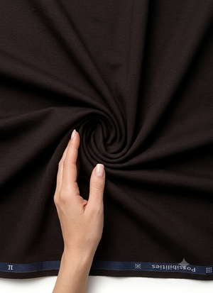 Brown Arvind Lycra stretchable trousers and suiting fabric, showing smooth, flexible material with a subtle textured pattern.