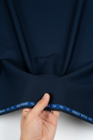 A close-up of dark navy blue fabric with a blue elastic trim at the top featuring the text 'DOLCE'VITA BY ronald' and 'ALL WEATHER'.