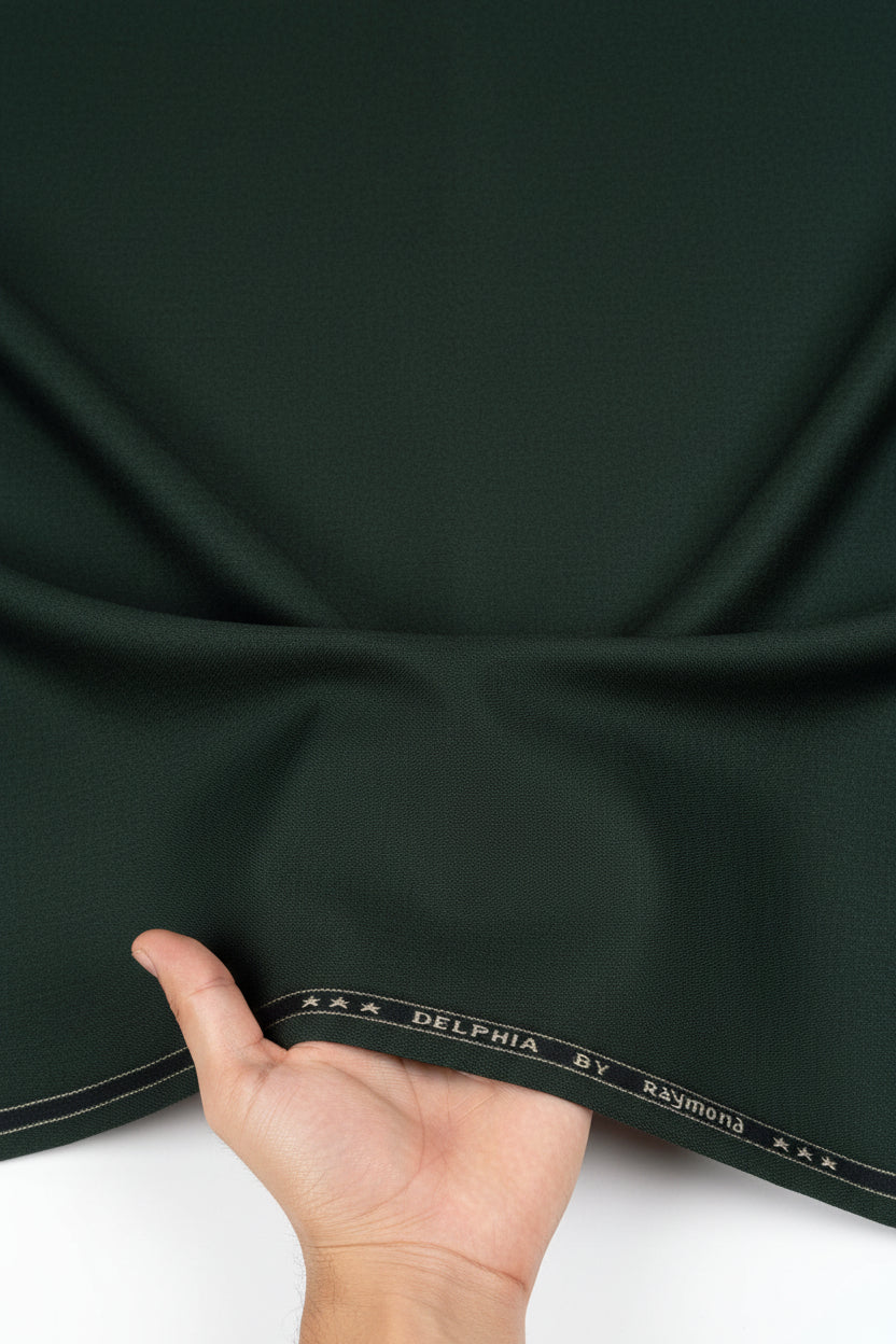 Raymond unstitched poly viscose trousers and suiting fabric in seaweed green, fabric swatch with folded edges and textured surface.