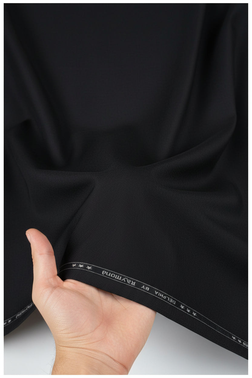 Raymond unstitched poly viscose fabric for trousers and suits in charcoal grey, showcasing the textured textile material.