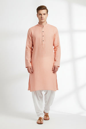 Deep peach Arvind linen shirt fabric, plain unstitched material with a smooth texture and lightweight feel for custom tailoring.