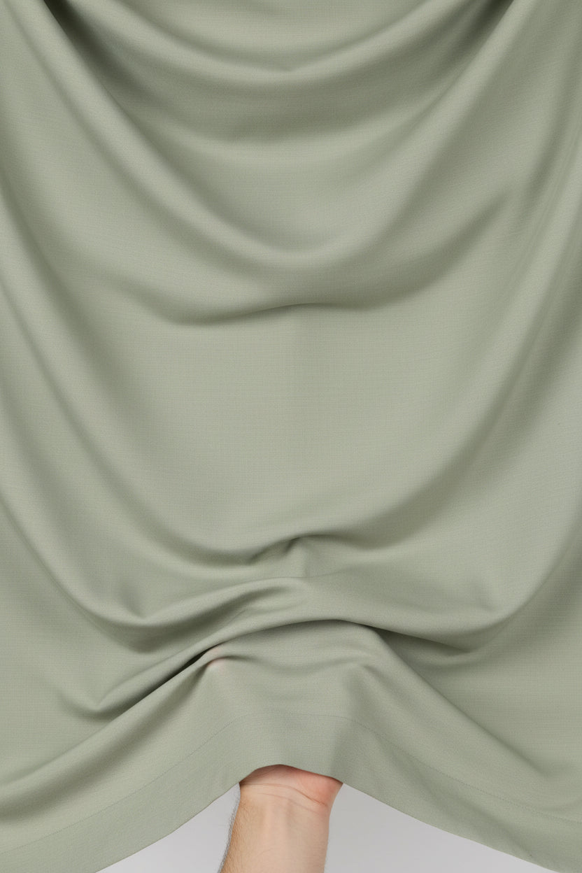 Olive green Tessuti satin unstitched shirting fabric from Mensfabric, smooth and shiny textile ideal for custom shirts.