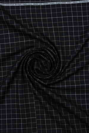 Arvind Giza cotton shirting fabric with white check pattern on black background, close-up view of fabric texture and design.