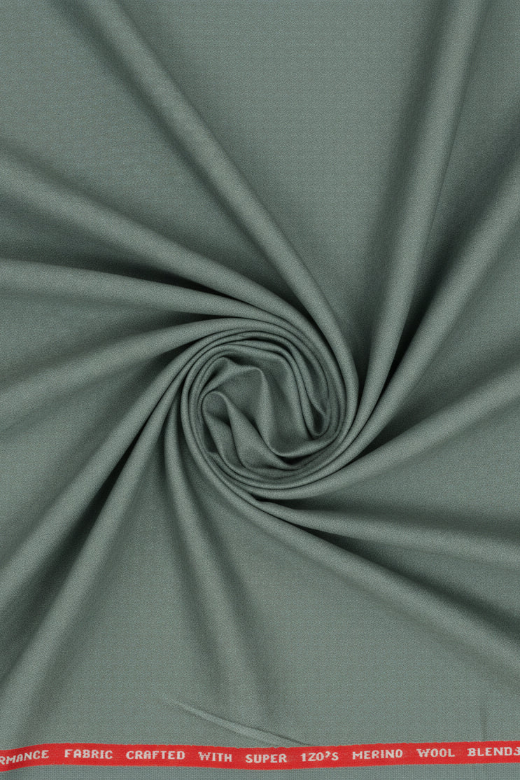 Raymond Luxurious unstitched polywool fabric in Pista Green for trousers and suiting, shown in close-up with fabric texture details.