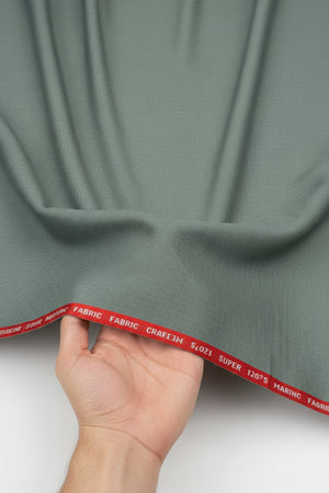 Raymond Luxurious unstitched polywool fabric in Pista Green, suitable for trousers and suiting, shown in close-up detail.