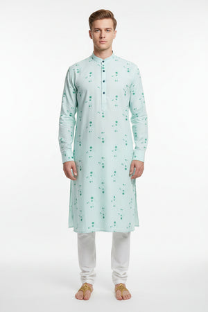 Light blue readymade kurta fabric with green floral patterns and '100% Cotton' label.