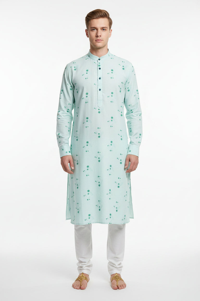 Light blue readymade kurta fabric with green floral patterns and '100% Cotton' label.