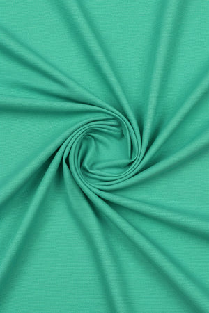 Parrot green Tresca cotton shirting fabric by Arvind, showcasing smooth unstitched textile with vibrant color and fine texture.