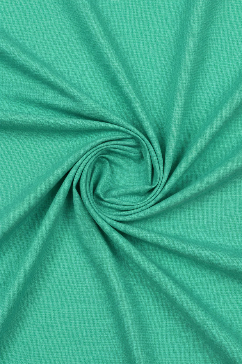 Parrot green Tresca cotton shirting fabric by Arvind, showcasing smooth unstitched textile with vibrant color and fine texture.