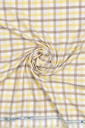 Yellow and brown check Tresca cotton shirting fabric by Arvind, featuring a white background and unstitched, luxurious cotton material.