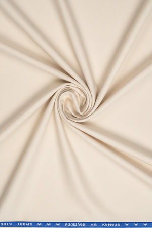 Raymond ivory polywool trousers and suiting fabric, showing a close-up of the textured textile with tailored appearance.