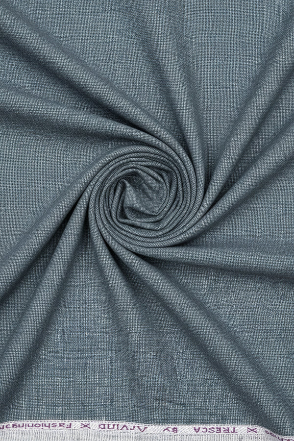 Gray Arvind linen trousers fabric close-up showing smooth, textured linen material suitable for tailored trousers.