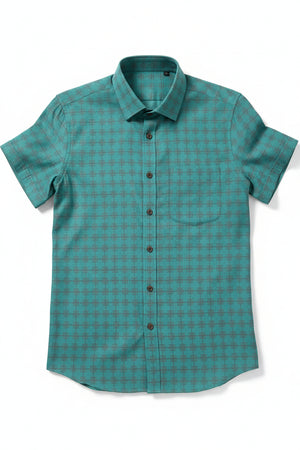 Teal green Tresca cotton shirting fabric by Arvind, showing soft, unstitched textile with detailed weave texture.