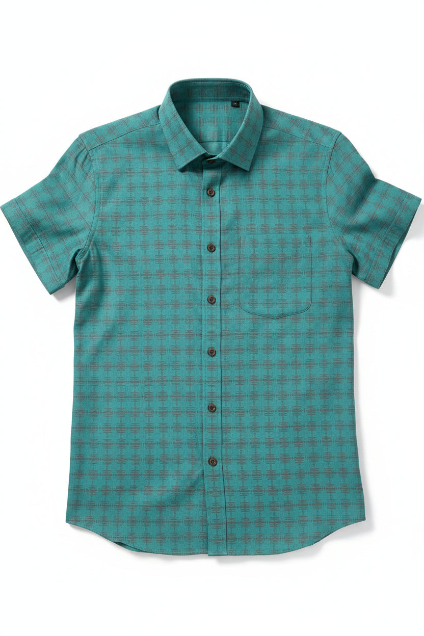 Teal green Tresca cotton shirting fabric by Arvind, showing soft, unstitched textile with detailed weave texture.