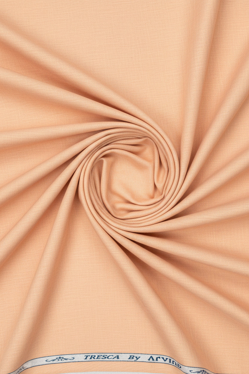 Light orange Arvind Tresca cotton unstitched shirting fabric showcasing smooth texture and vibrant color.