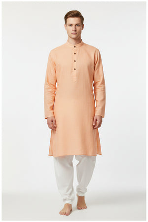 Light orange Arvind Tresca cotton unstitched shirting fabric, close-up of the textured cotton material.