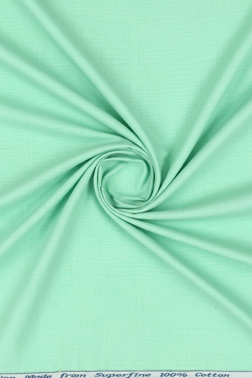 Mint green Arvind cotton shirting fabric with a smooth texture and subtle weave pattern, ideal for stylish shirts.