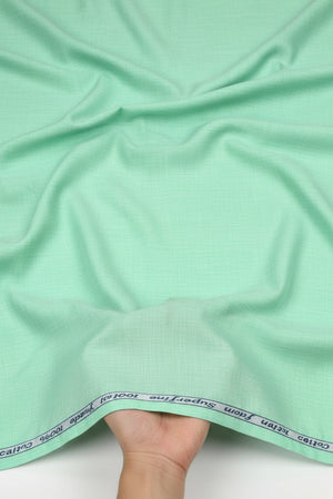 Mint green Arvind cotton shirting fabric with a smooth texture, ideal for tailored shirts and lightweight clothing.