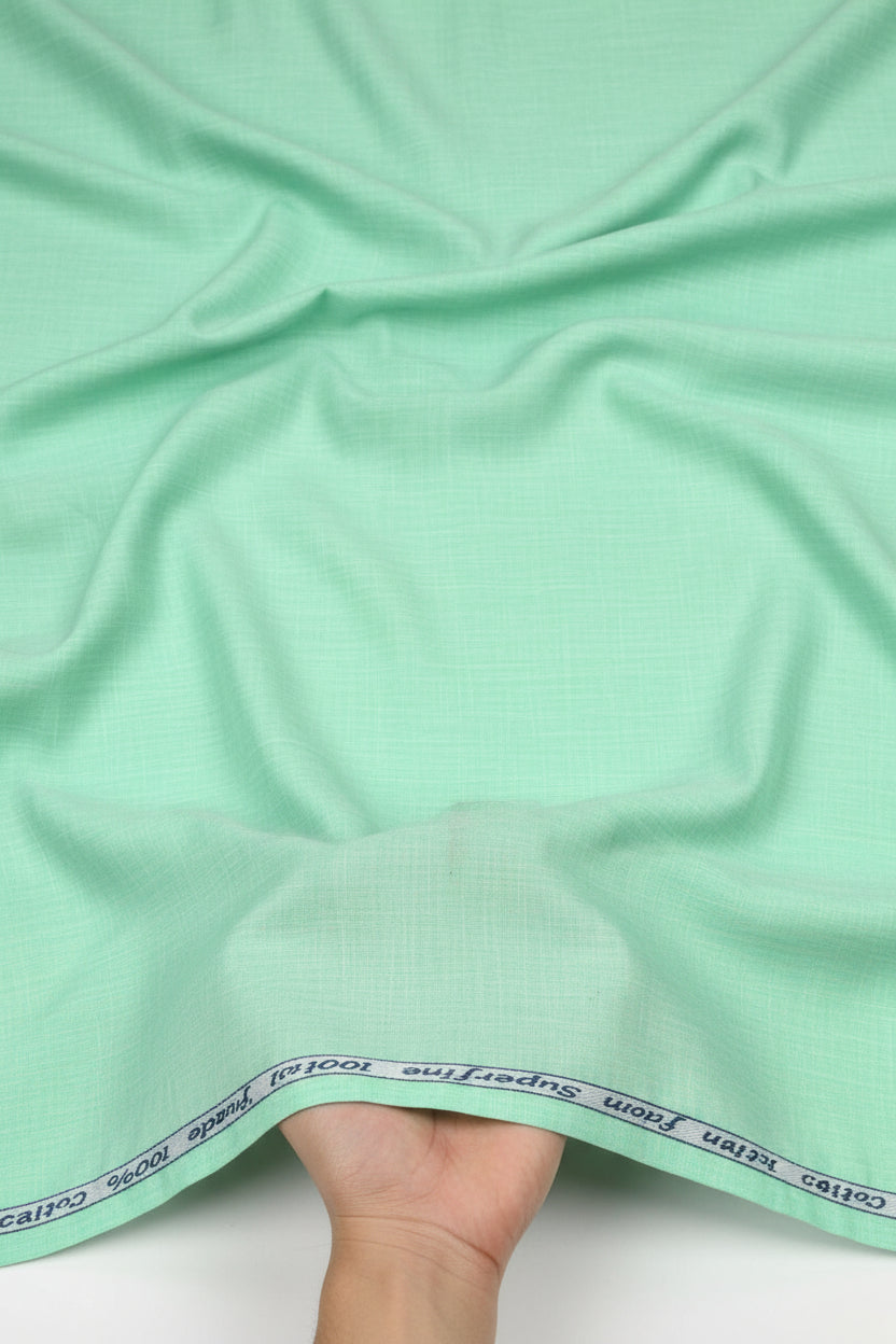 Mint green Arvind cotton shirting fabric with a smooth texture, ideal for tailored shirts and lightweight clothing.
