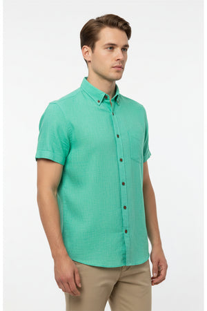 Arvind Tresca cotton shirting fabric in aquamarine green, showing a close-up of the textured, lightweight fabric with vibrant color.