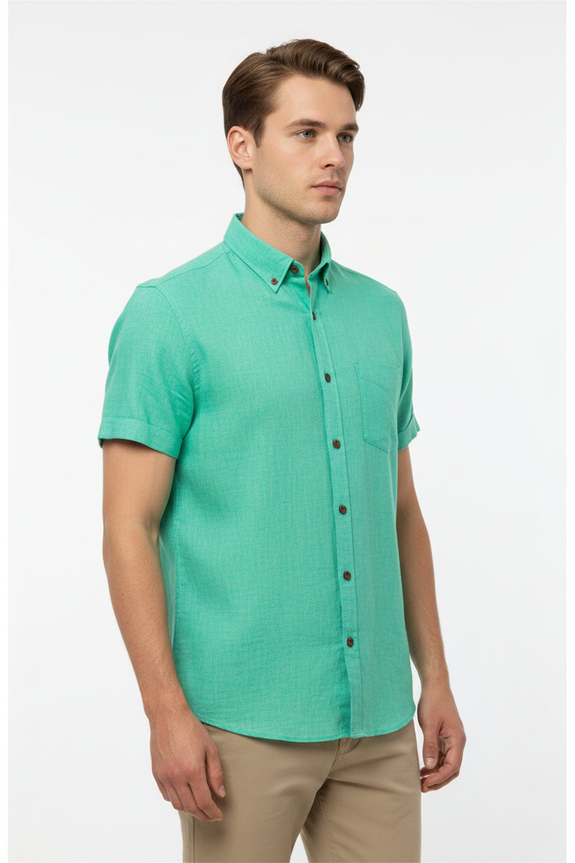 Arvind Tresca cotton shirting fabric in aquamarine green, showing a close-up of the textured, lightweight fabric with vibrant color.