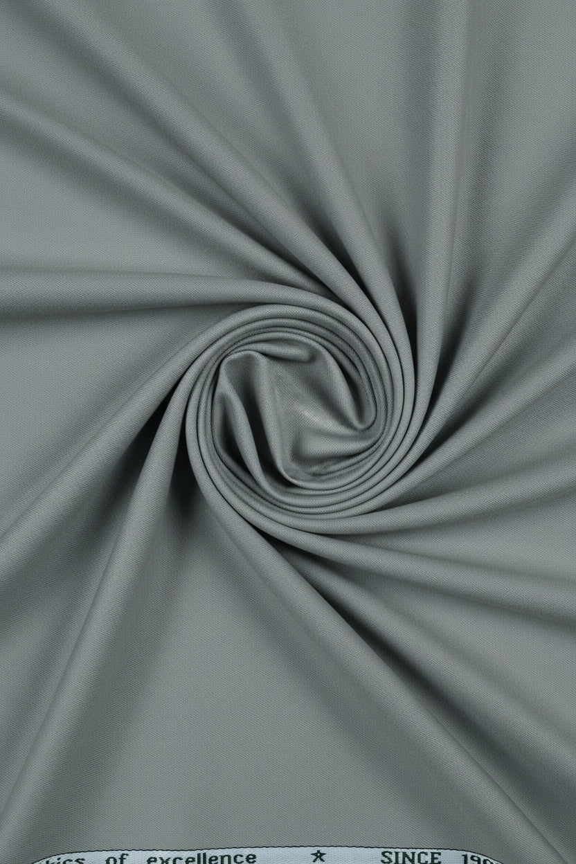 Grey Mafatlal unstitched poly viscose trouser and suiting fabric, shown in a fabric roll with detailed texture.