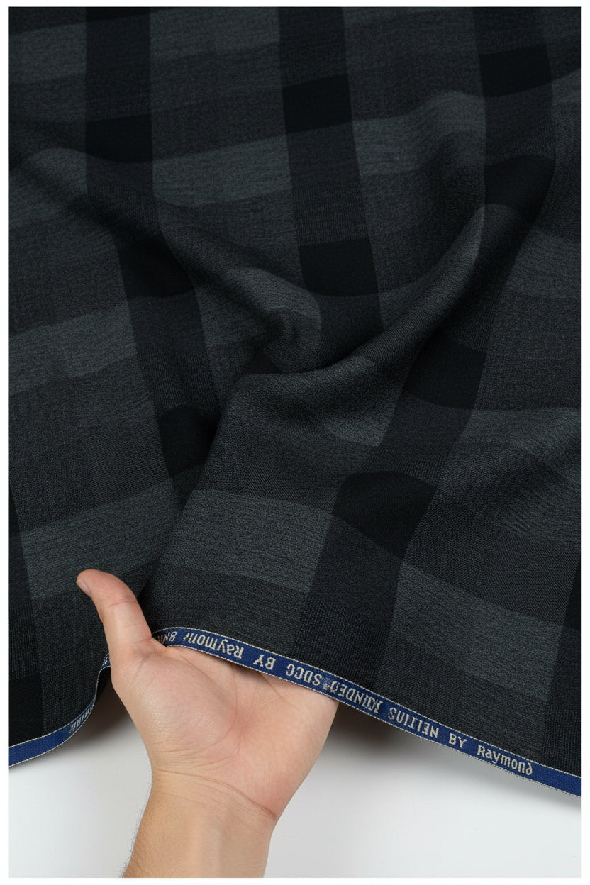 Raymond luxurious unstitched poly wool trouser and suiting fabric in charcoal grey, suitable for tailoring and formal wear.