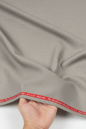 Raymond beige unstitched poly wool fabric for trousers and suiting, showing textured fabric detail and color.