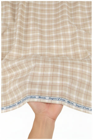 Beige Tresca cotton checks shirting fabric by Arvind, showing a close-up of the woven check pattern and fabric texture.